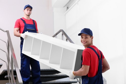 Staff separating cardboard, wood, and metal for recycling