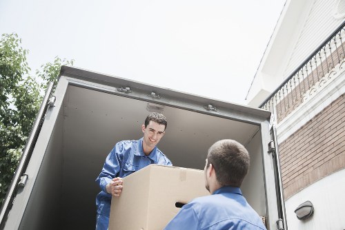 Removal team loading household items into a van in a Twickenham street